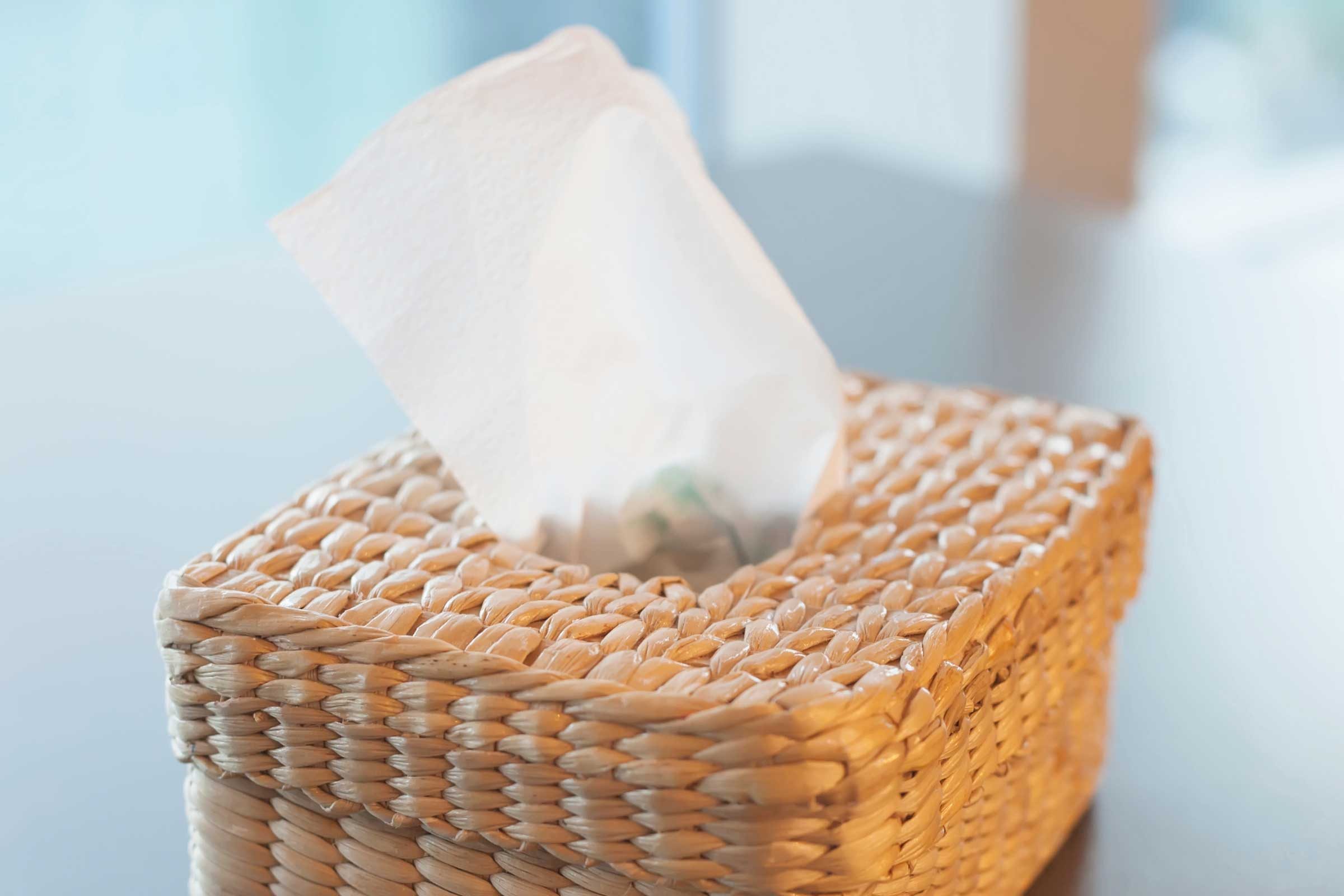 Wicker box of tissues on a table.