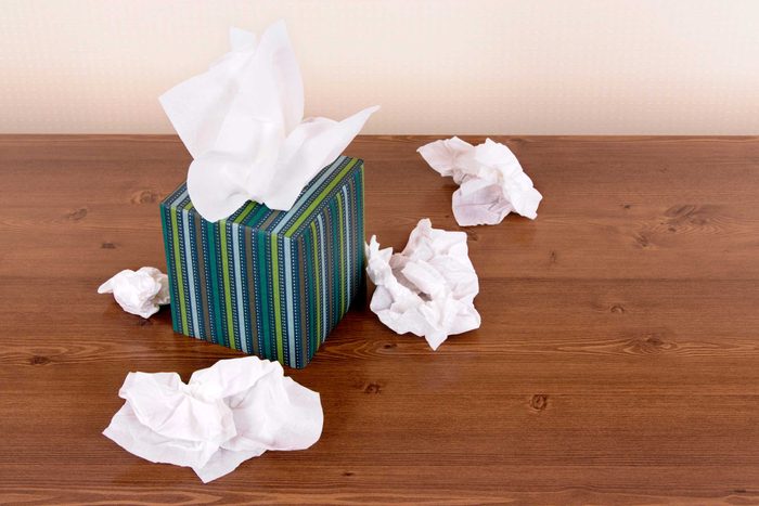 Box of tissues on a hardwood floor.
