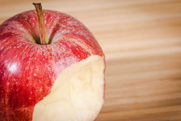 half-eaten red apple