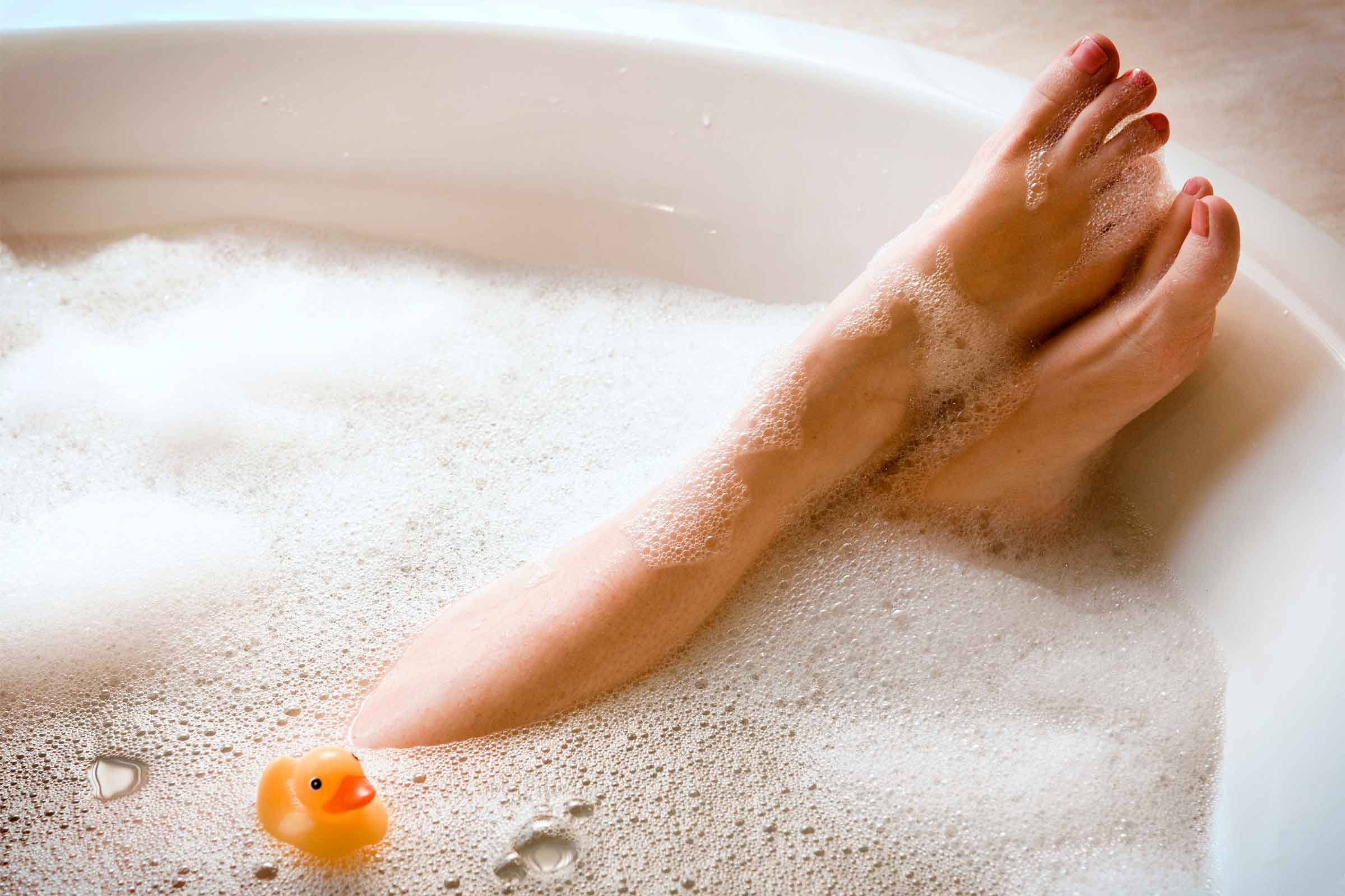 Woman's feet peaking out of a bubble bath.