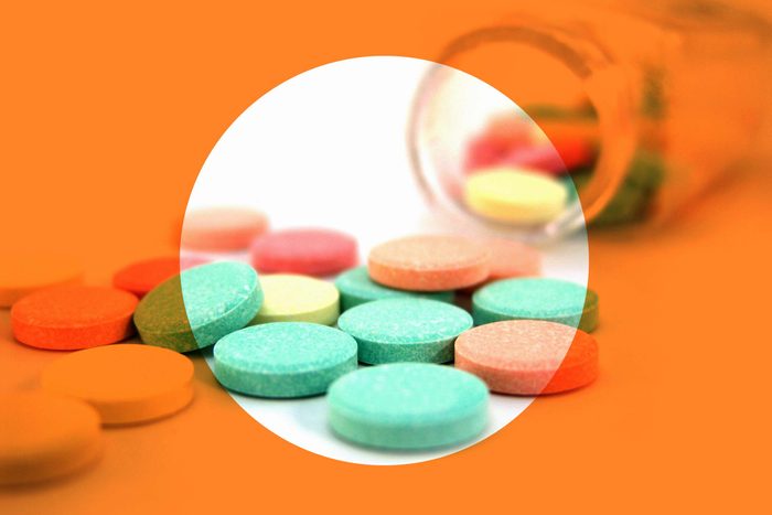 bottle of antacids on its side, spilling out tablets