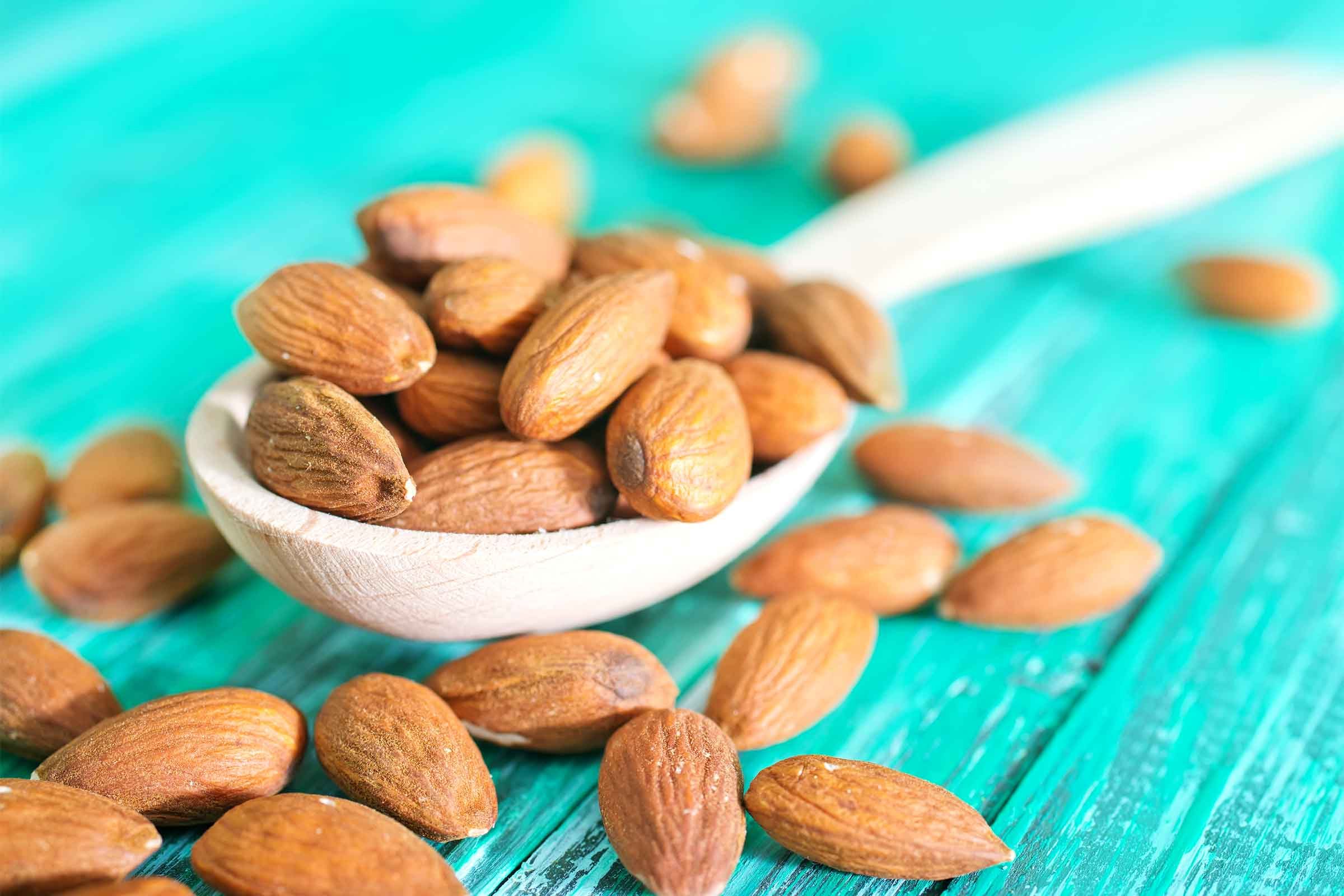 almonds in a spoon and spread over a table