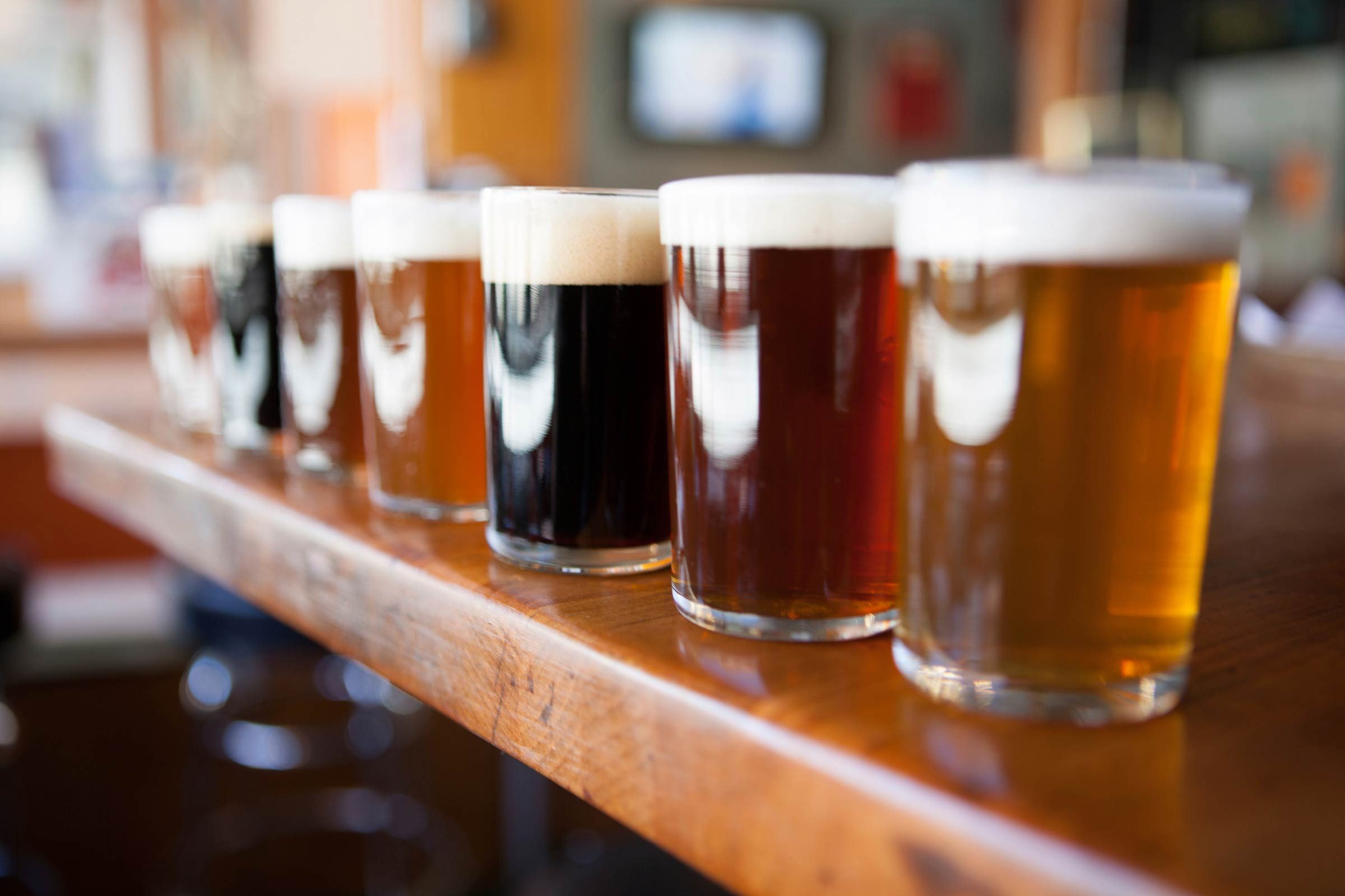 beer glasses lined up on a bar