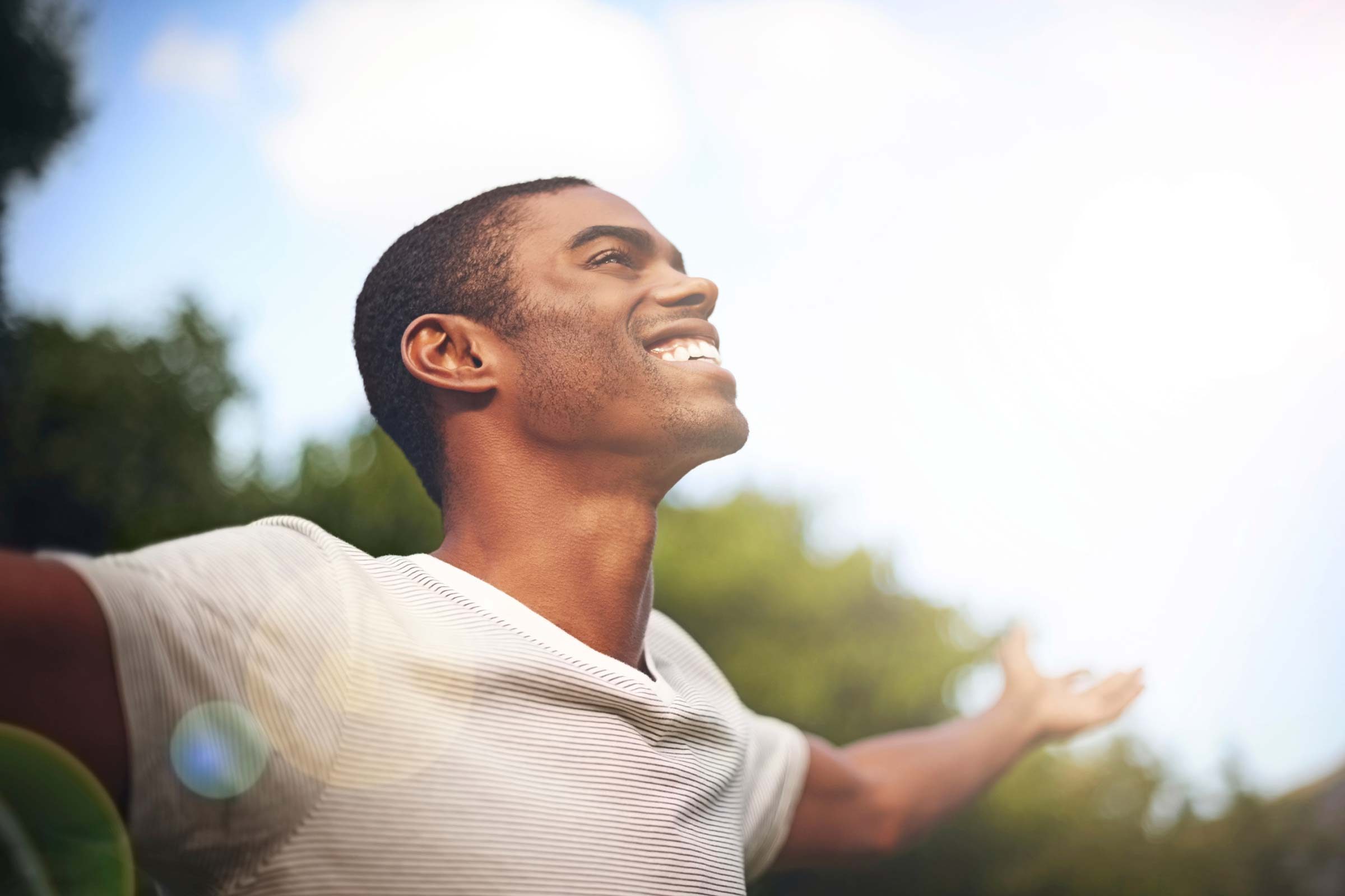 happy man with arms outstretched