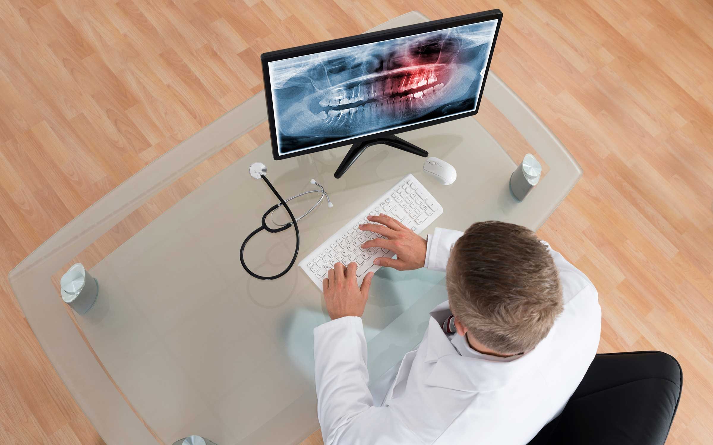 Dentist looking at X-ray of teeth
