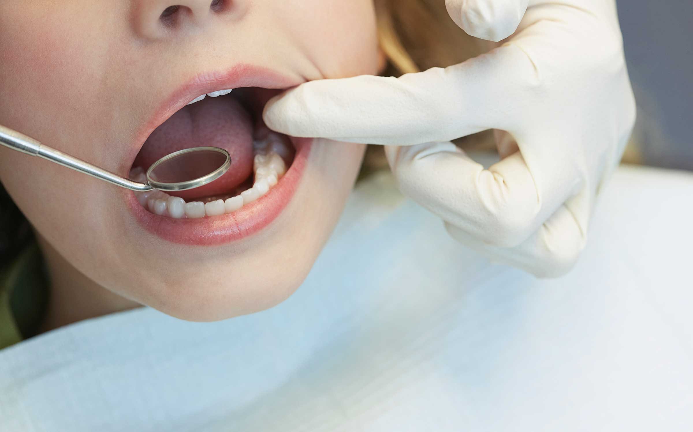 Dentist looking inside mouth