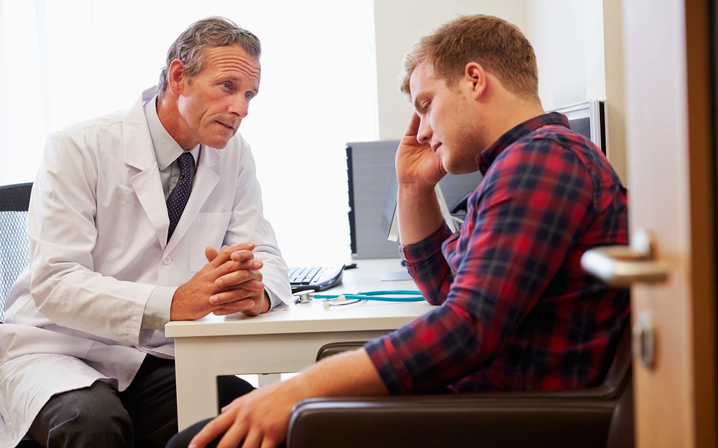 Man sitting with doctor