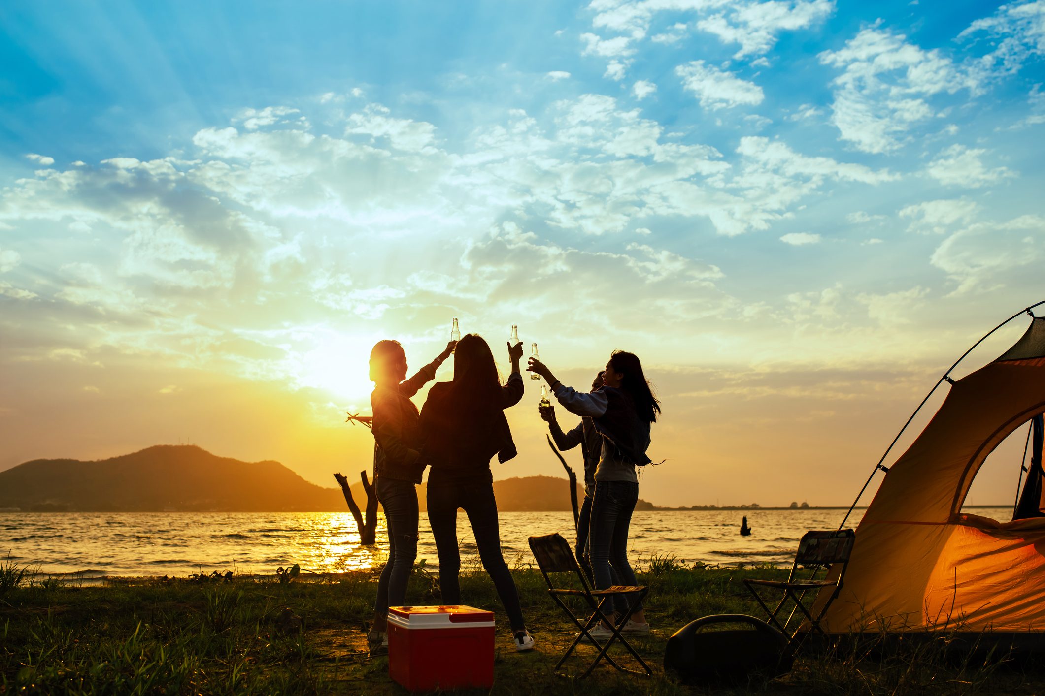 friends having fun at the beach during sunset