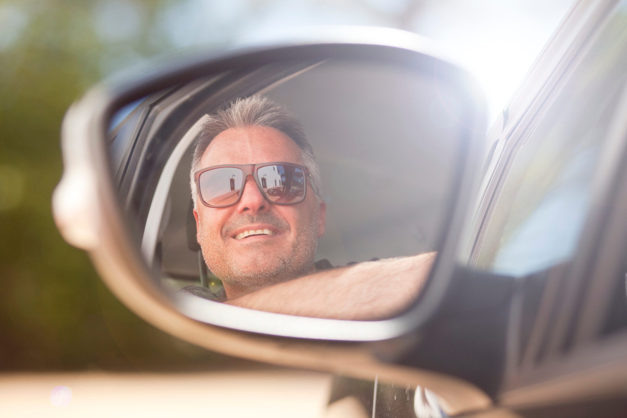 man in side view mirror reflection