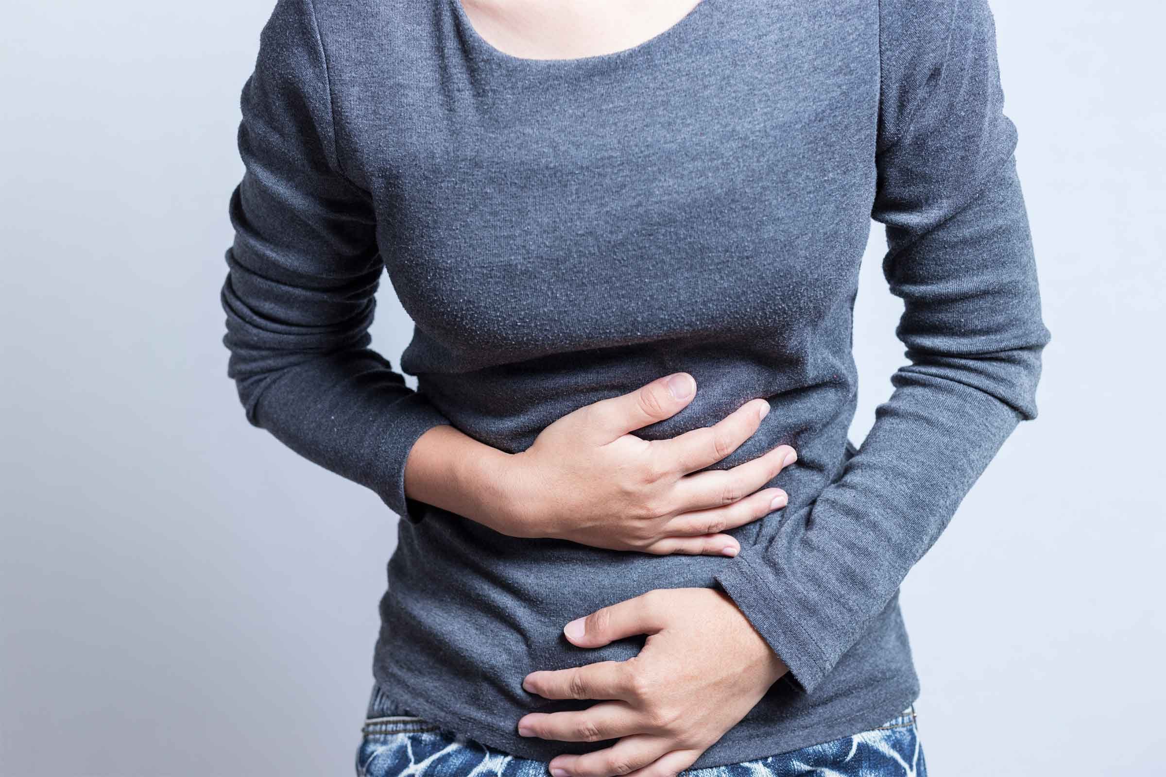 woman with hands on stomach