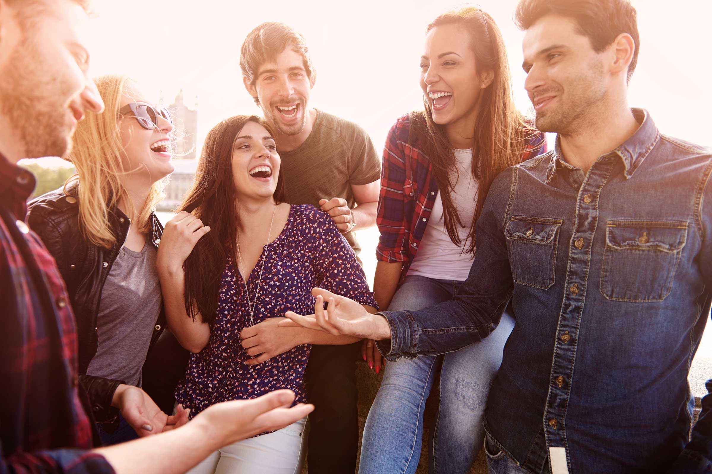 Men talking in front of laughing group