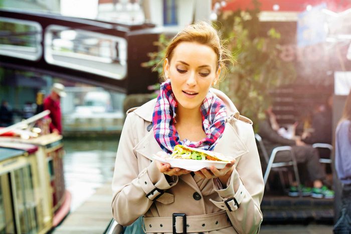Woman walking with a plate of food