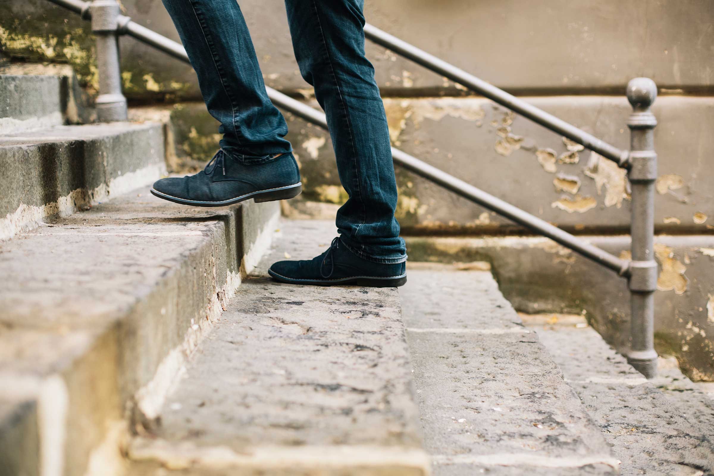 close up of just lower legs and feet of someone climbing the stairs