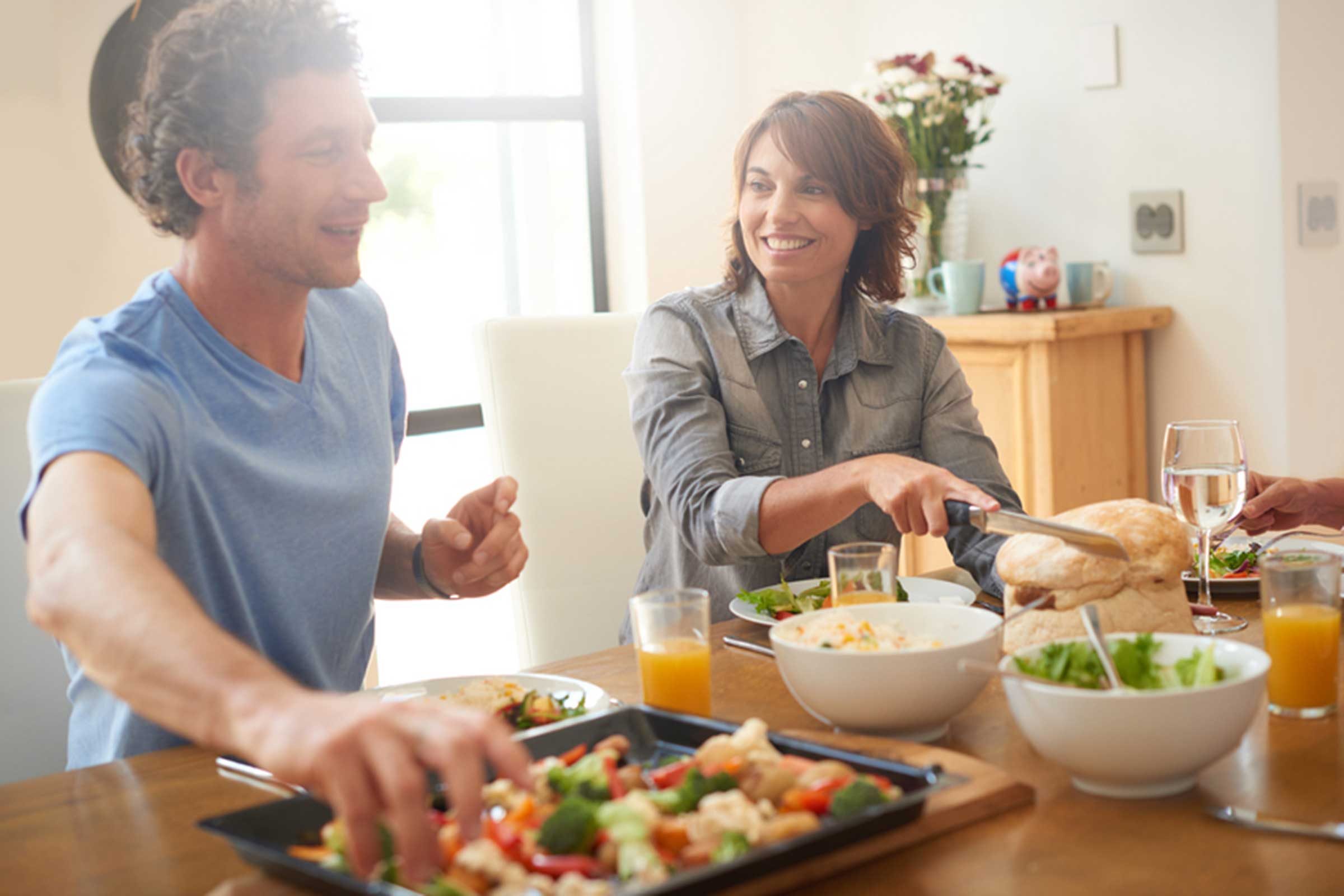 Man and woman eating at table