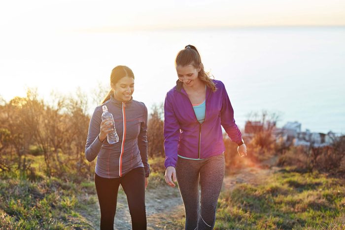 women walking on an outdoor path