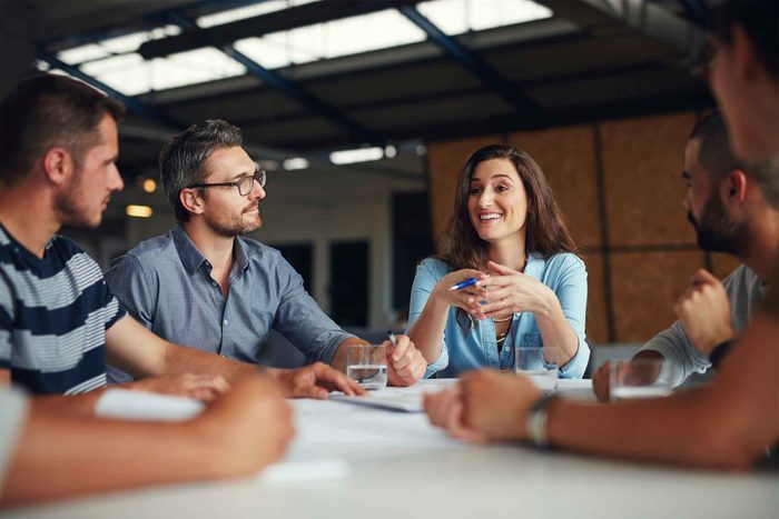 group listening to woman speaking