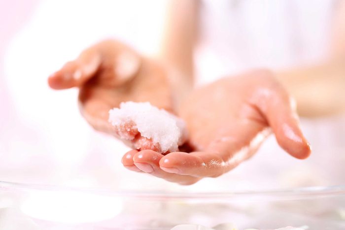 close up of hands holding facial scrub