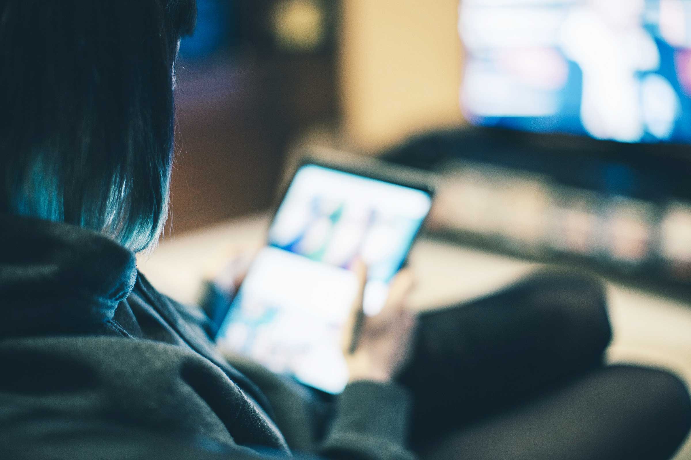 woman looking at tablet