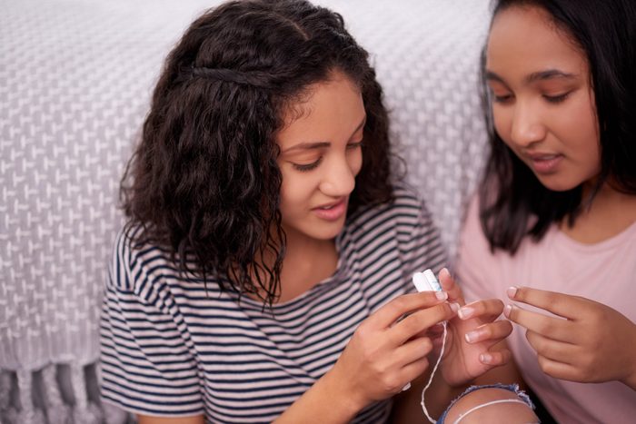 two young girls holding tampons