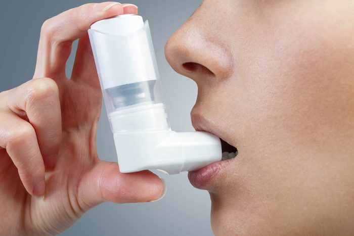 woman using inhaler