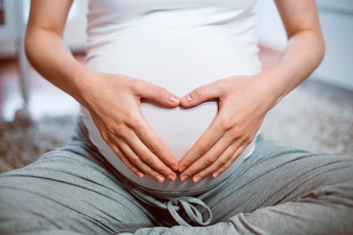 pregnant woman with hands on belly