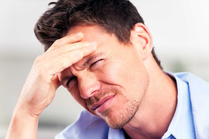 man with hand on forehead