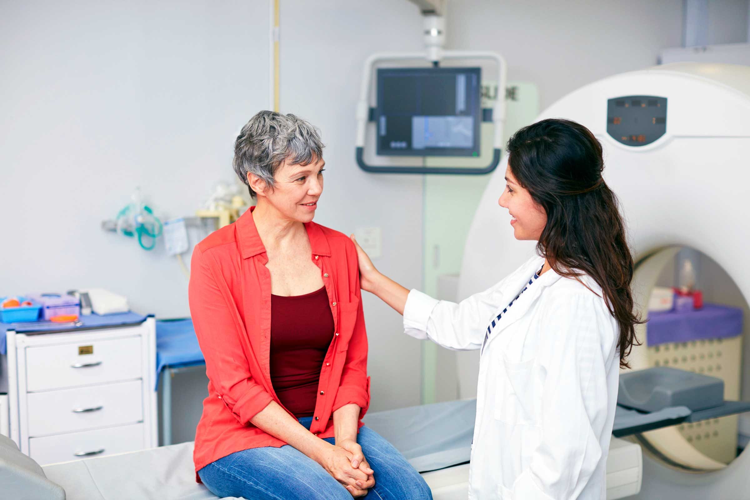 doctor talking to gray-haired woman