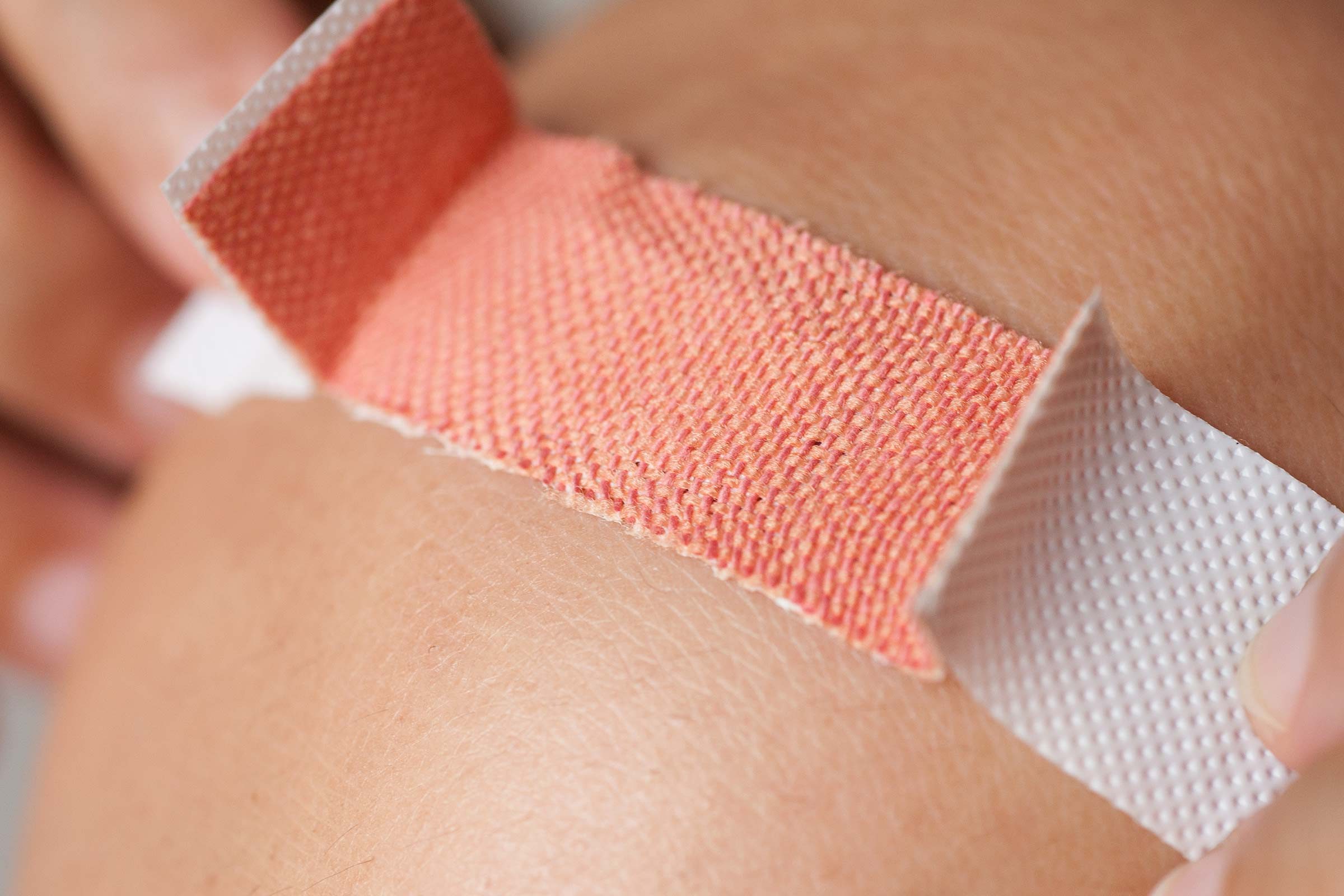 applying a band-aid to a cut