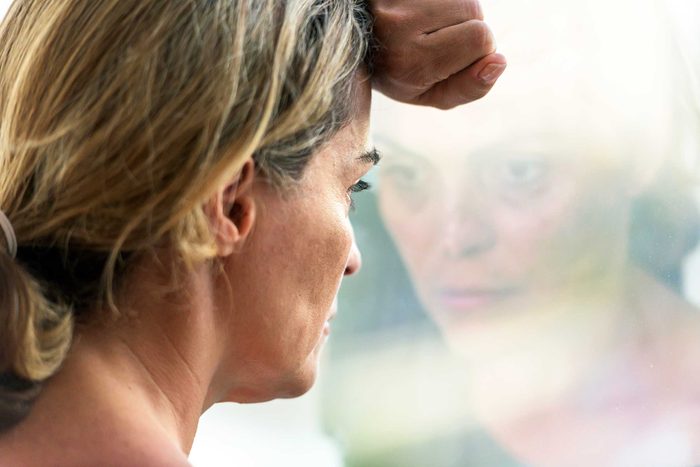 dejected woman staring out a window