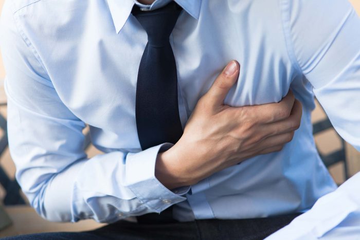 businessman clutching his chest