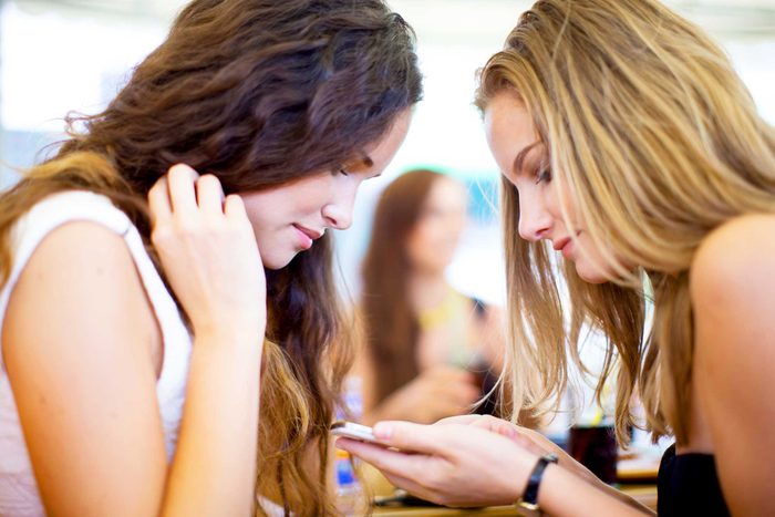 two women looking at a cell phone