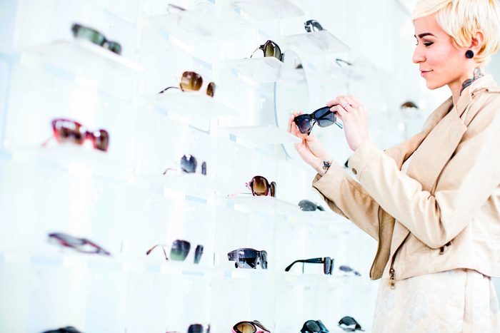 woman looking at sunglasses