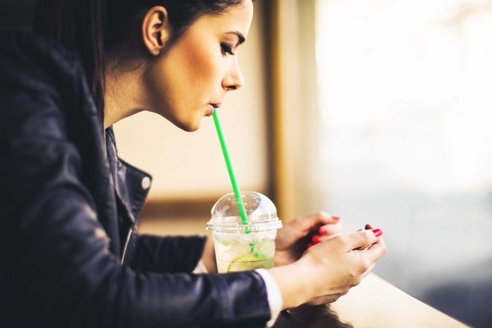 woman drinking iced green tea