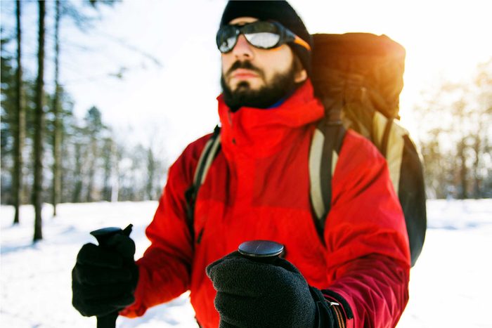 man wearing sunglasses in snow