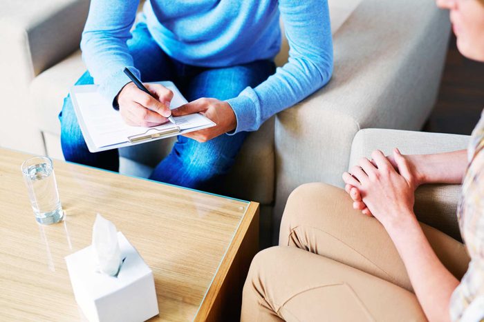 therapist sitting with patient, taking notes