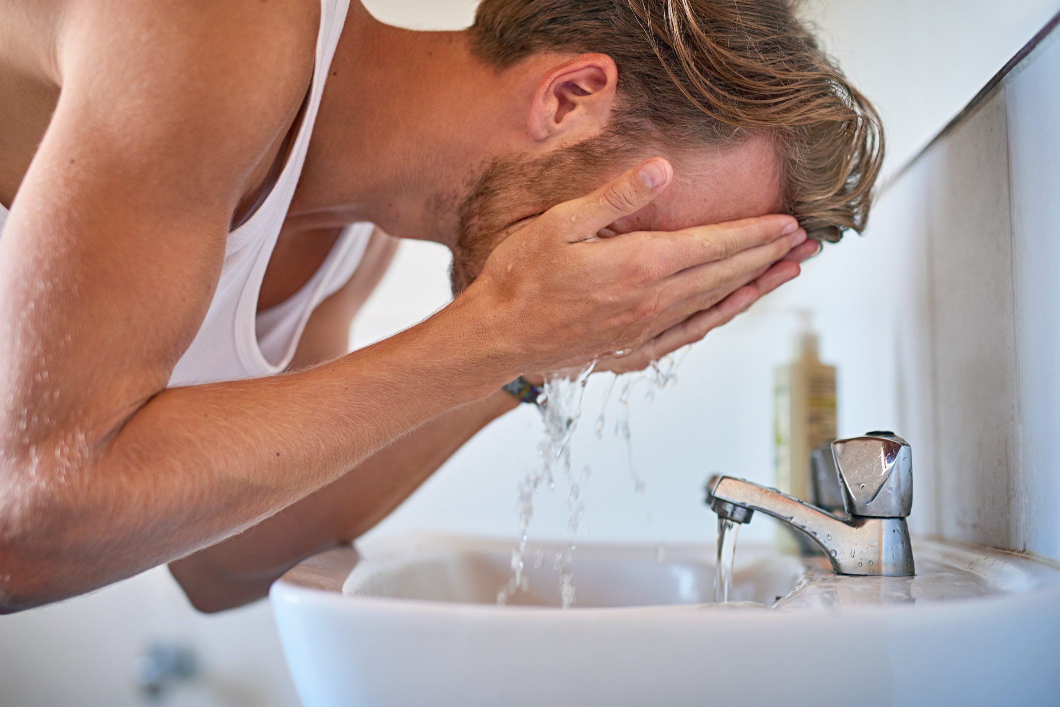 man washing his face