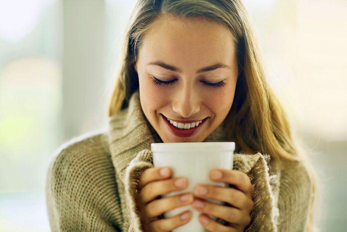 woman holding a large white mug
