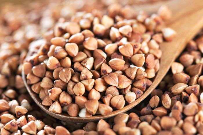 dried buckwheat with wooden spoon full