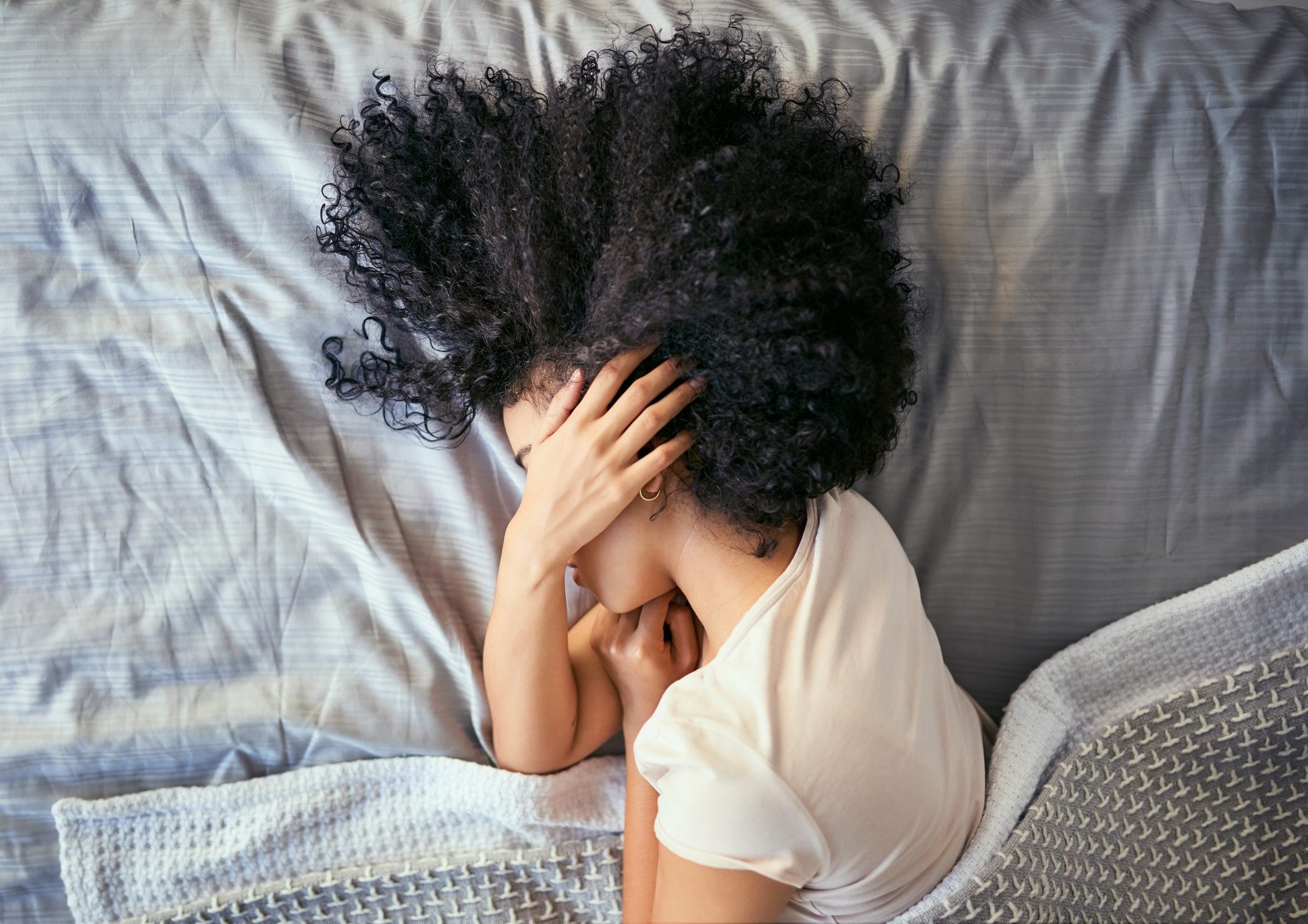 woman laying in bed tired