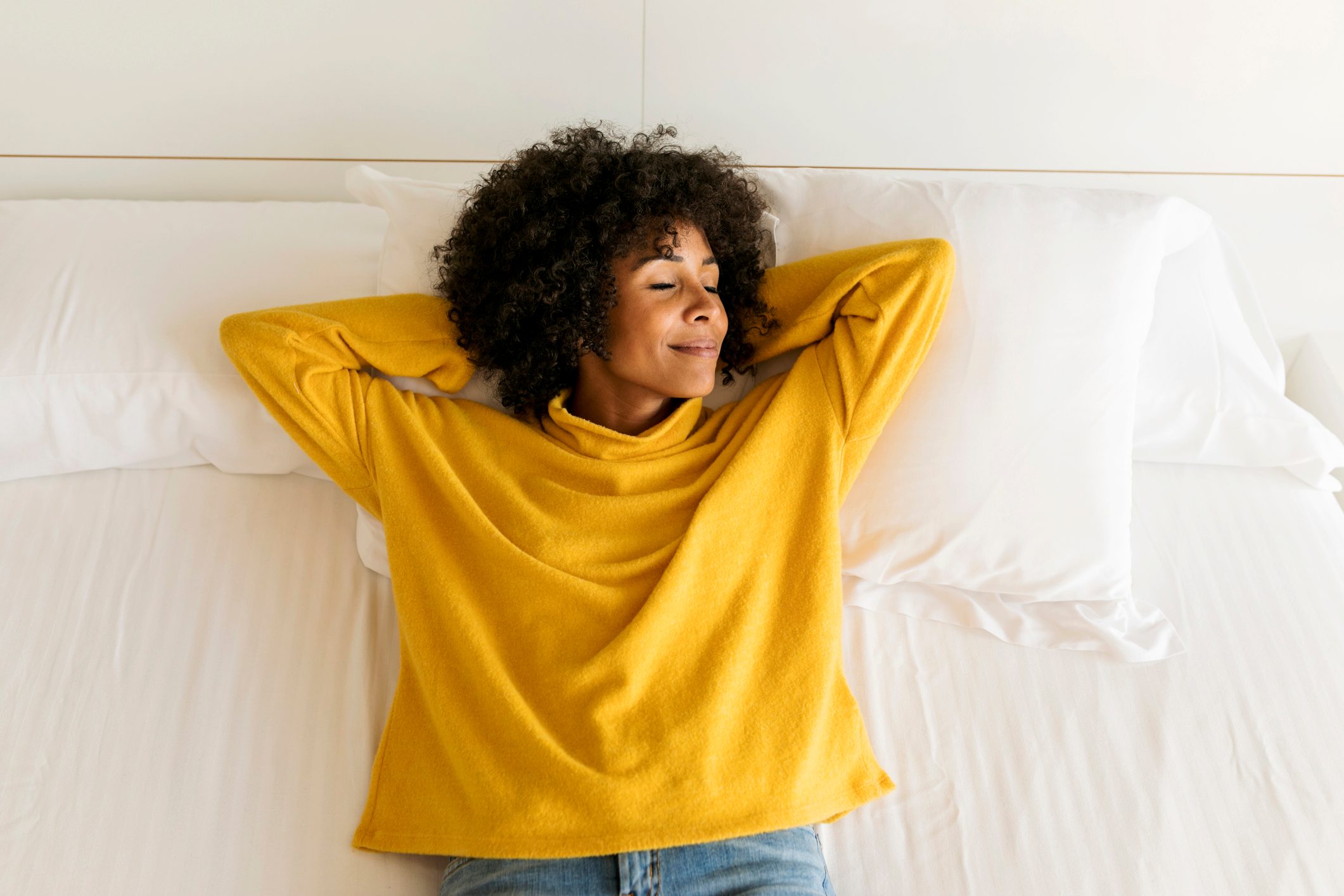 woman laying in bed relaxing