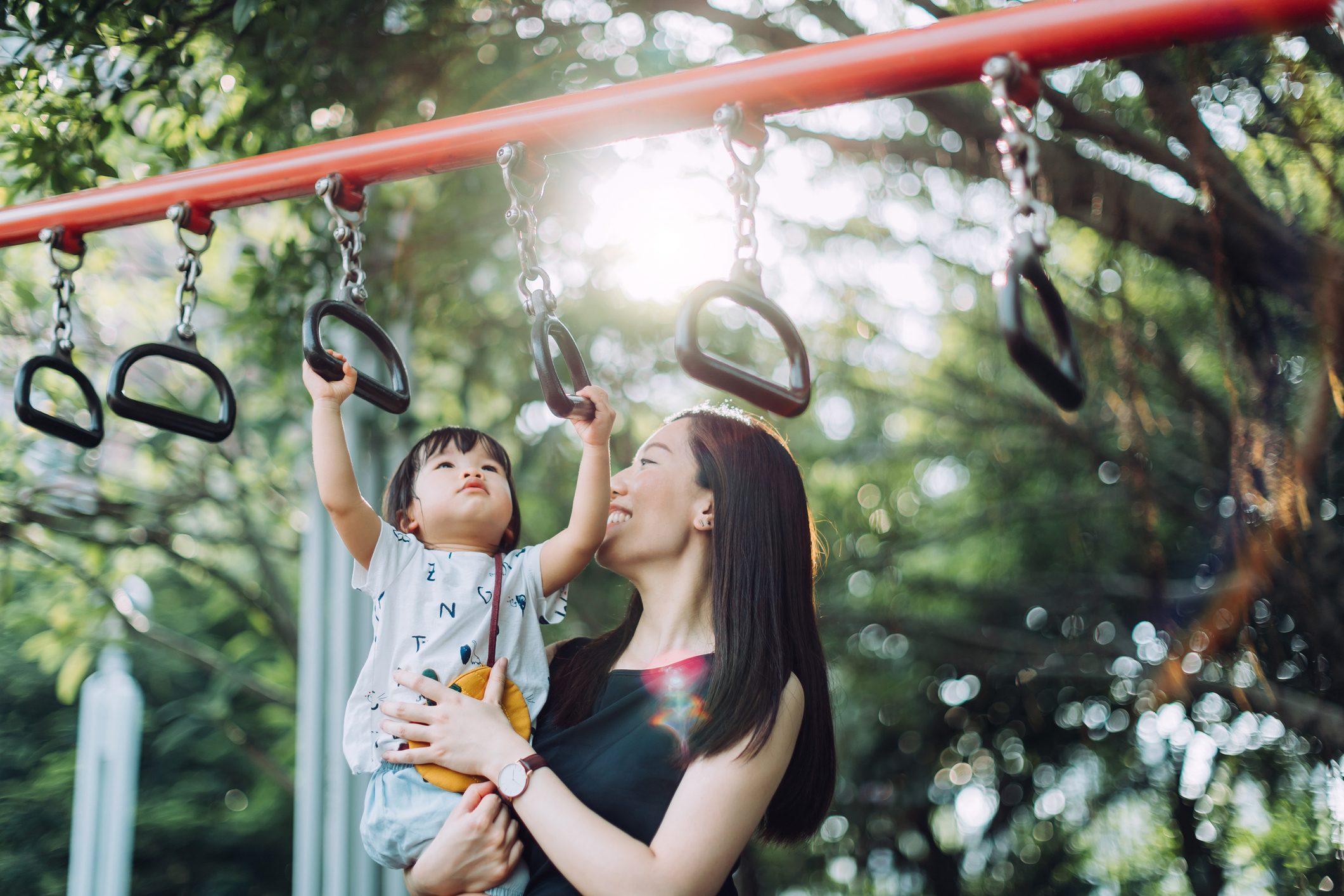 mother playing with her daughter at the playground