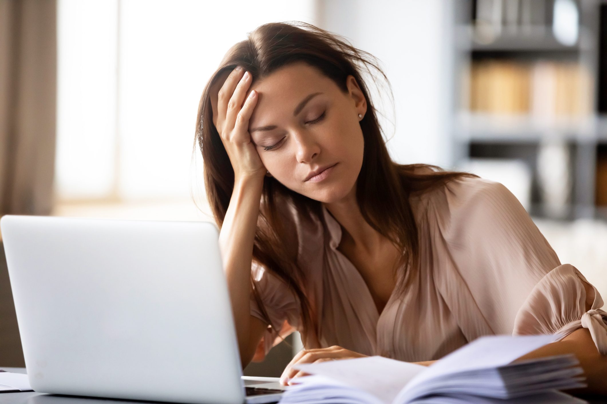 tired young woman trying to do work