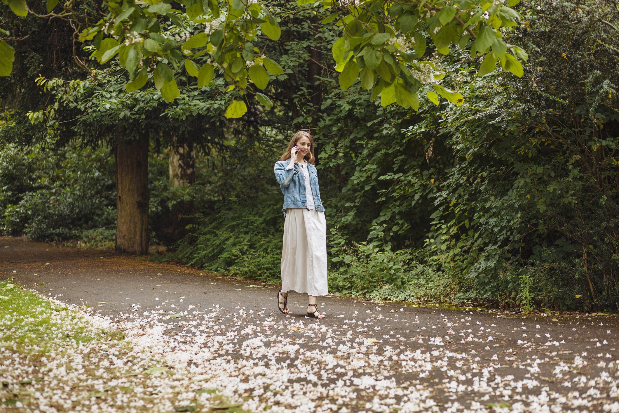 young woman talking on the phone while walking outside