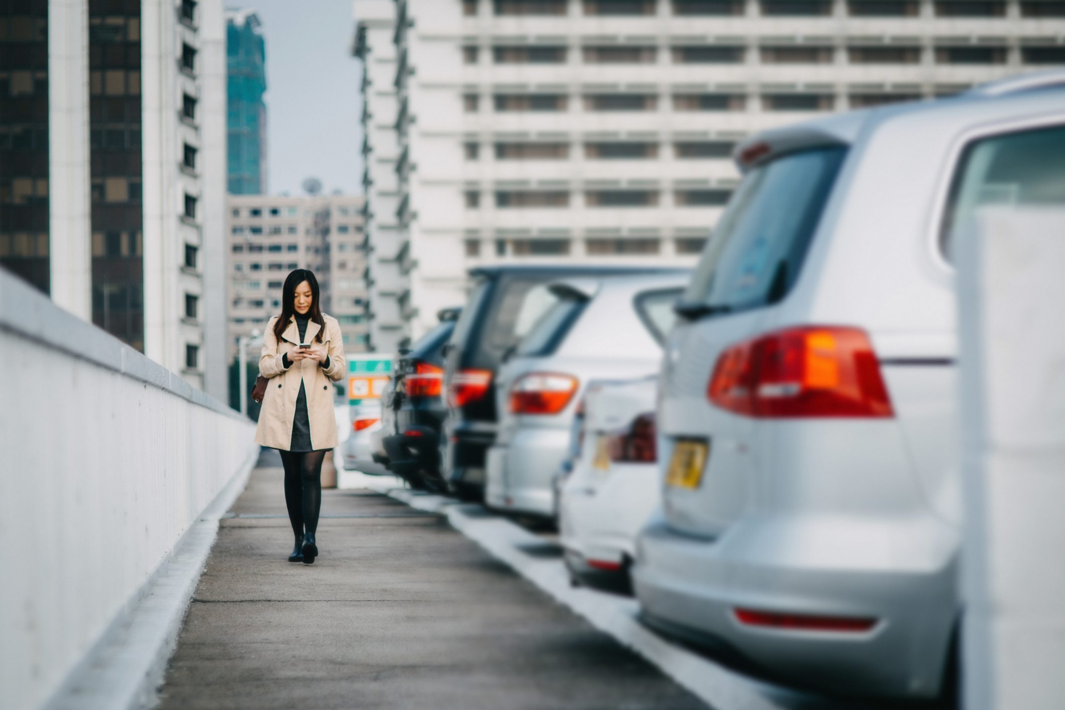 young woman walking through parking lot