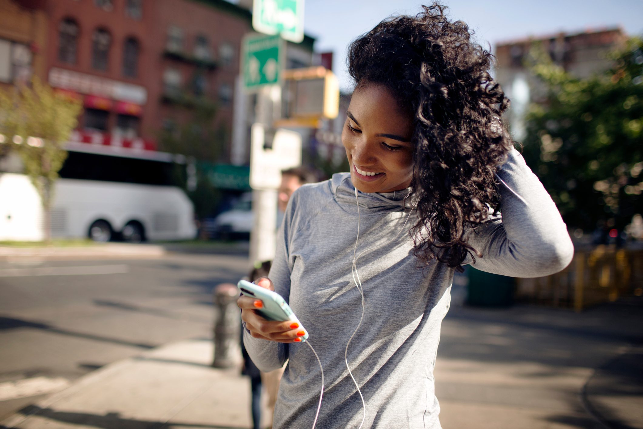 woman looking at phone while exercising