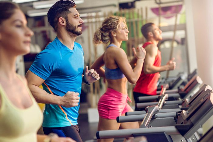 people running on treadmills in a gym