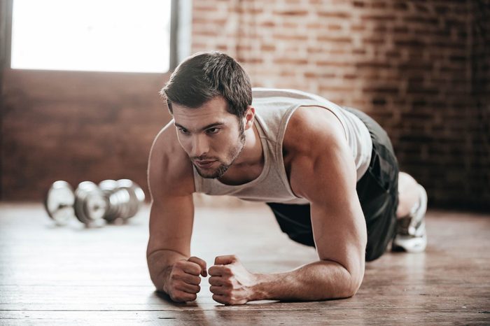 man in workout gear doing a plank