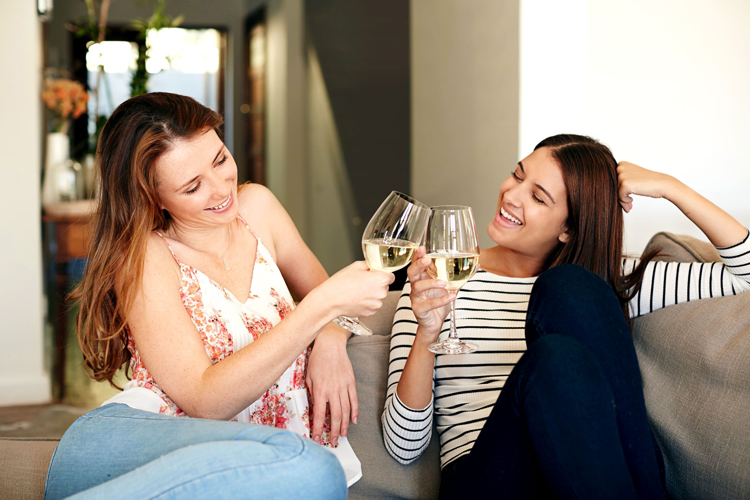 two women drinking and toasting
