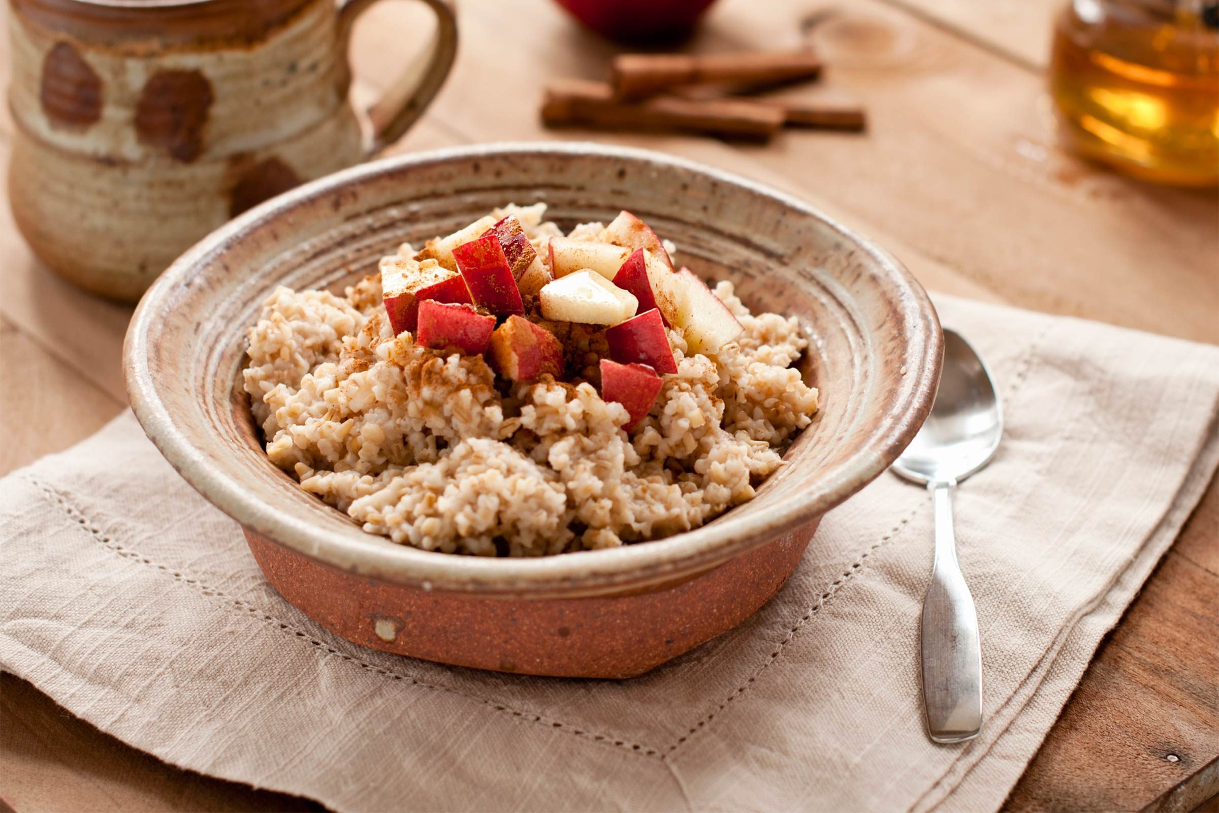 oatmeal with sliced apples in ceramic bowl