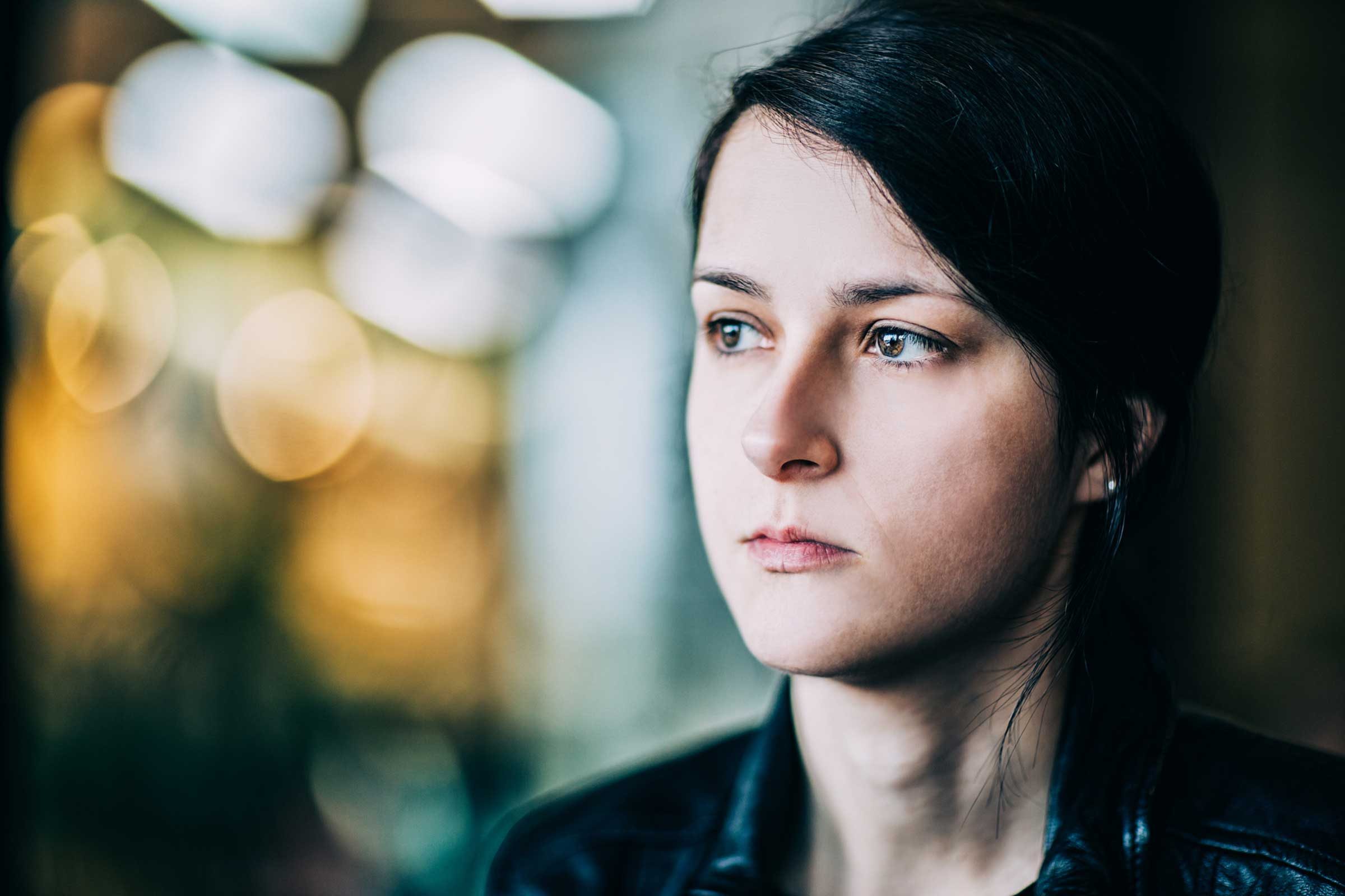 Serious-looking woman with blurry background